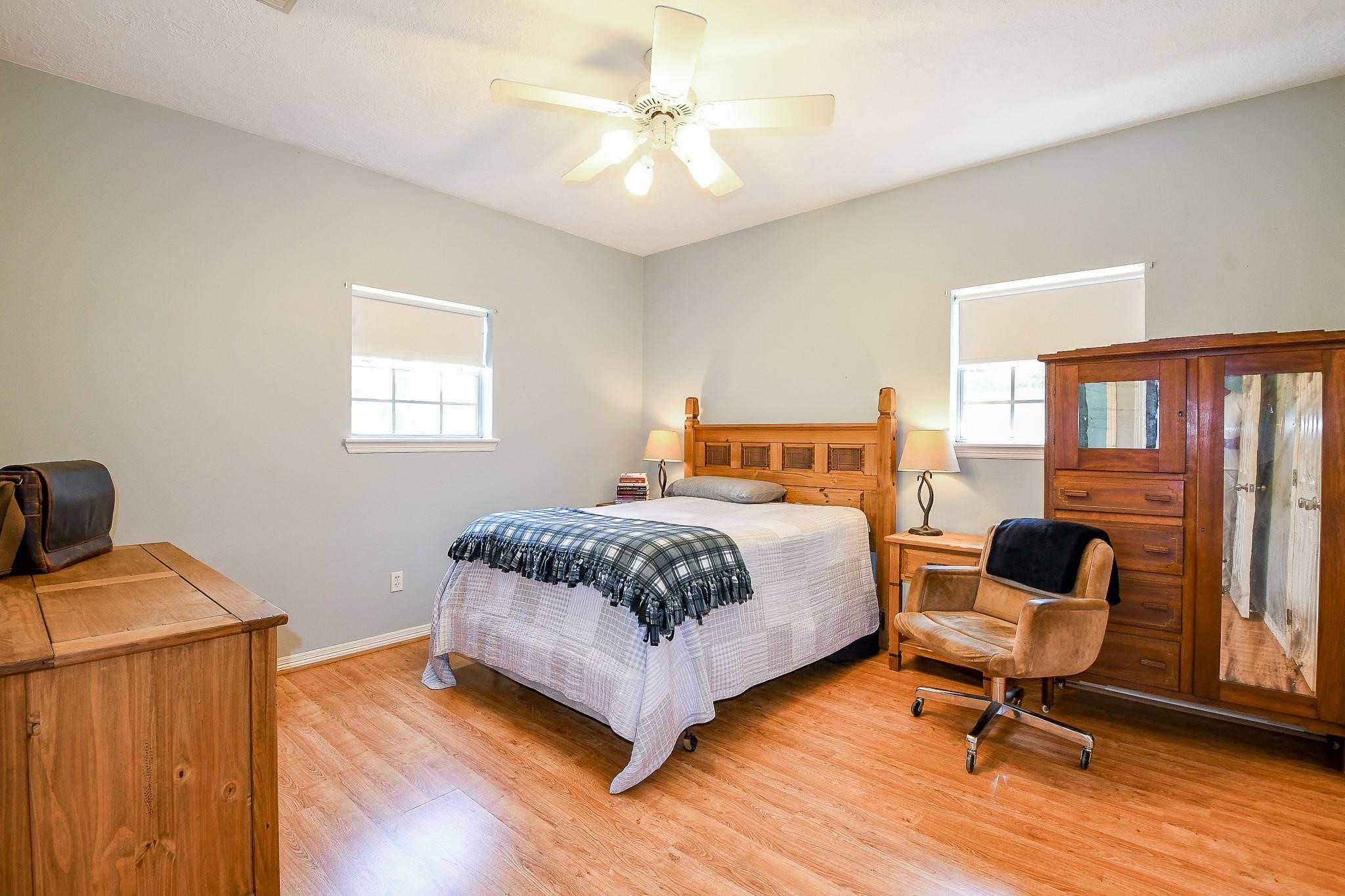 22035 Buescher Road Tomball, TX 77377 - Photo 27 of 44 a bedroom with a bed and a lounge chair