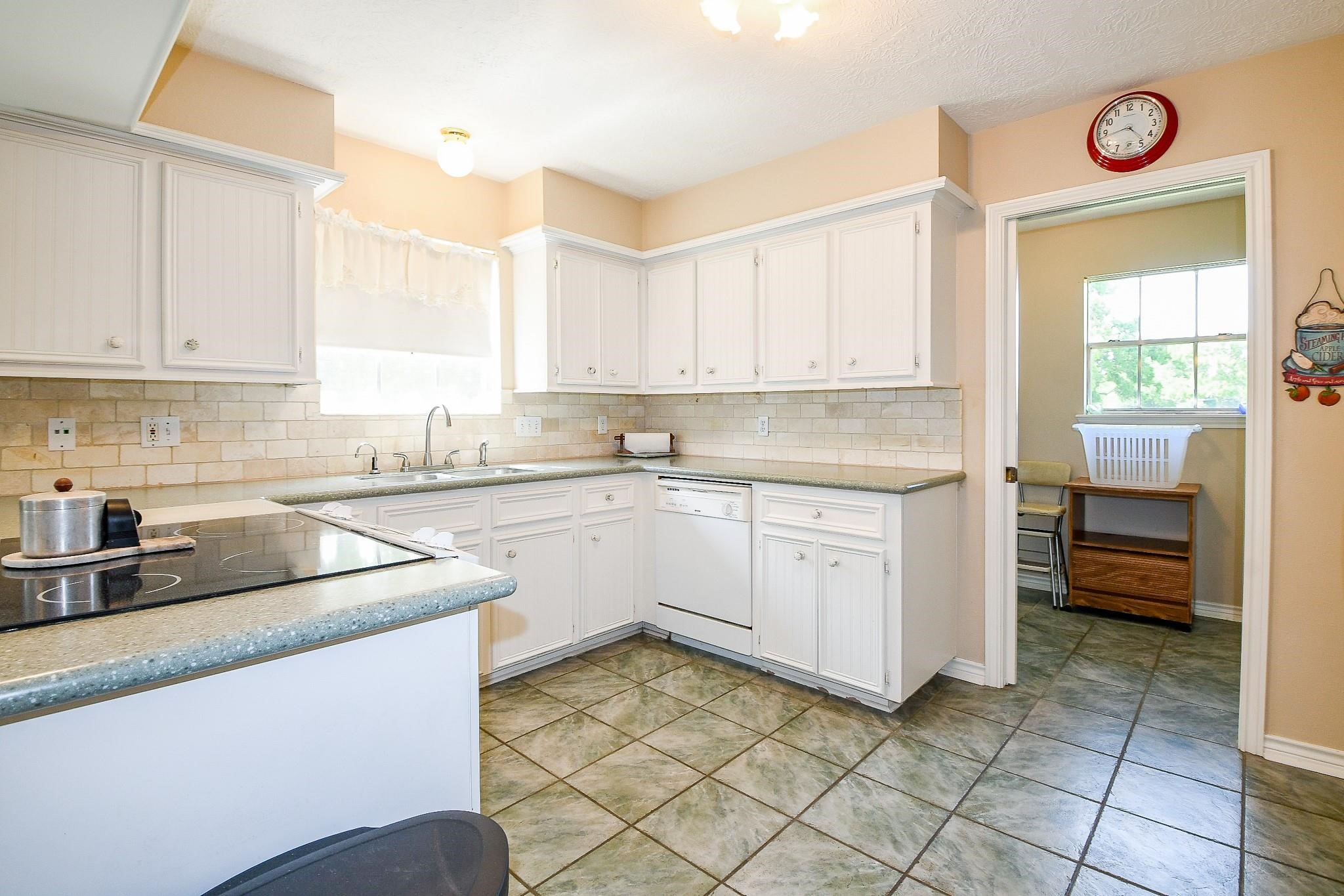 22035 Buescher Road Tomball, TX 77377 - Photo 37 of 44 a kitchen with a sink window and cabinets