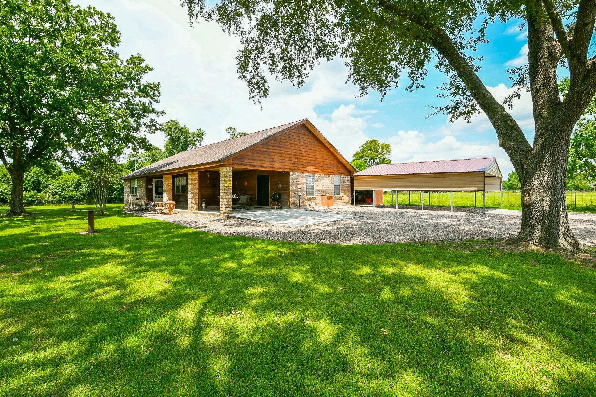 22035 Buescher Road Tomball, TX 77377 - Photo 4 of 44 a front view of a house with a garden