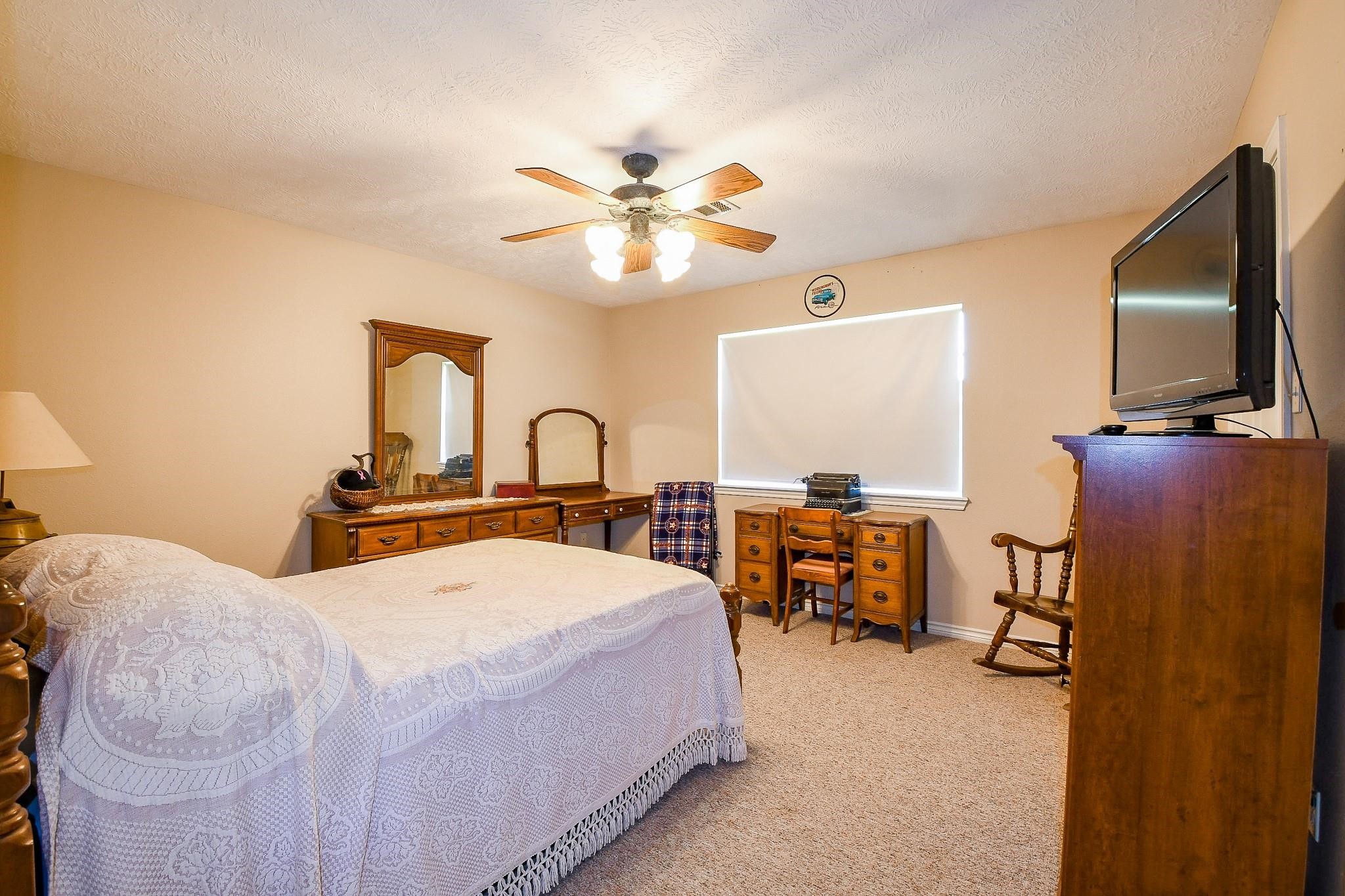 22035 Buescher Road Tomball, TX 77377 - Photo 41 of 44 a bedroom with a bed and a flat screen tv