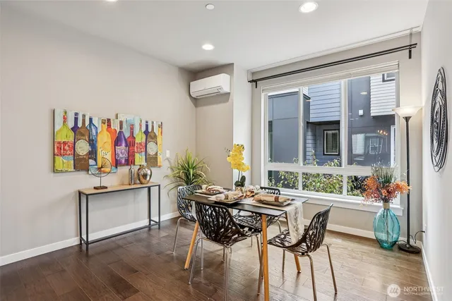 a dining room with furniture and wooden floor