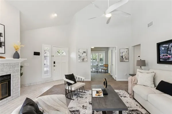 a living room with furniture a fireplace and a table