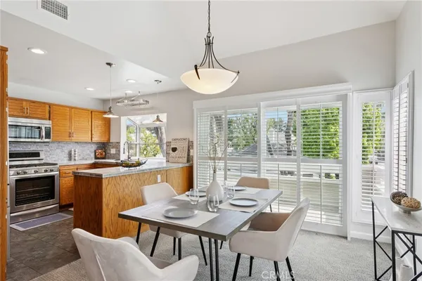 a view of a dining room with furniture window and outside view