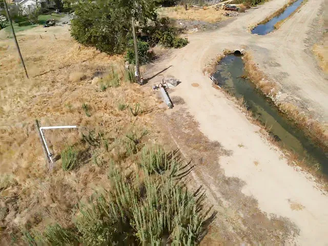an aerial view of a house with a yard and lake view