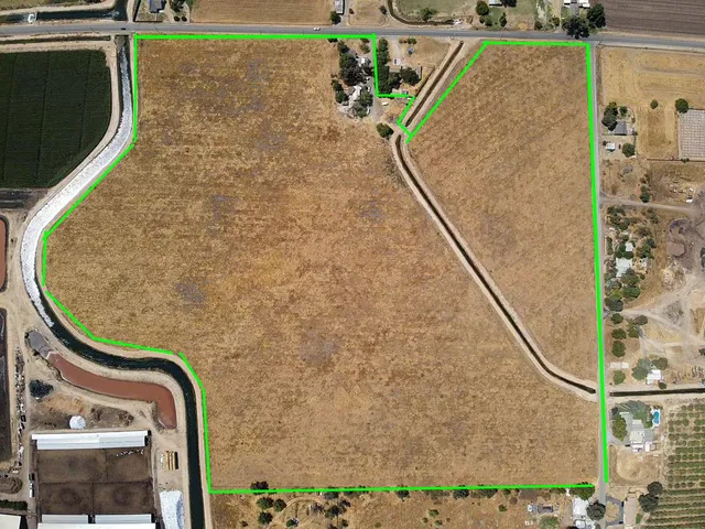 a white house with a tree in the background