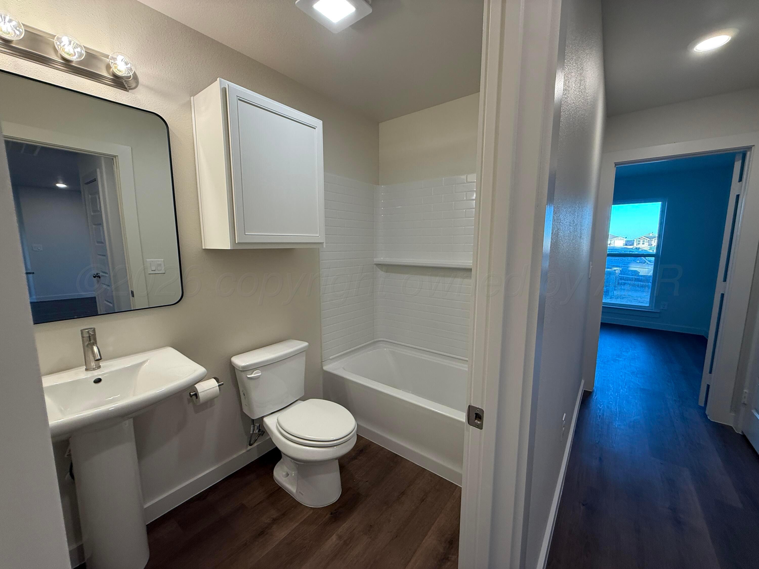 2911 Ranch House Road Amarillo, TX 79124 - Photo 11 of 18 a white toilet sitting next to a bathroom sink
