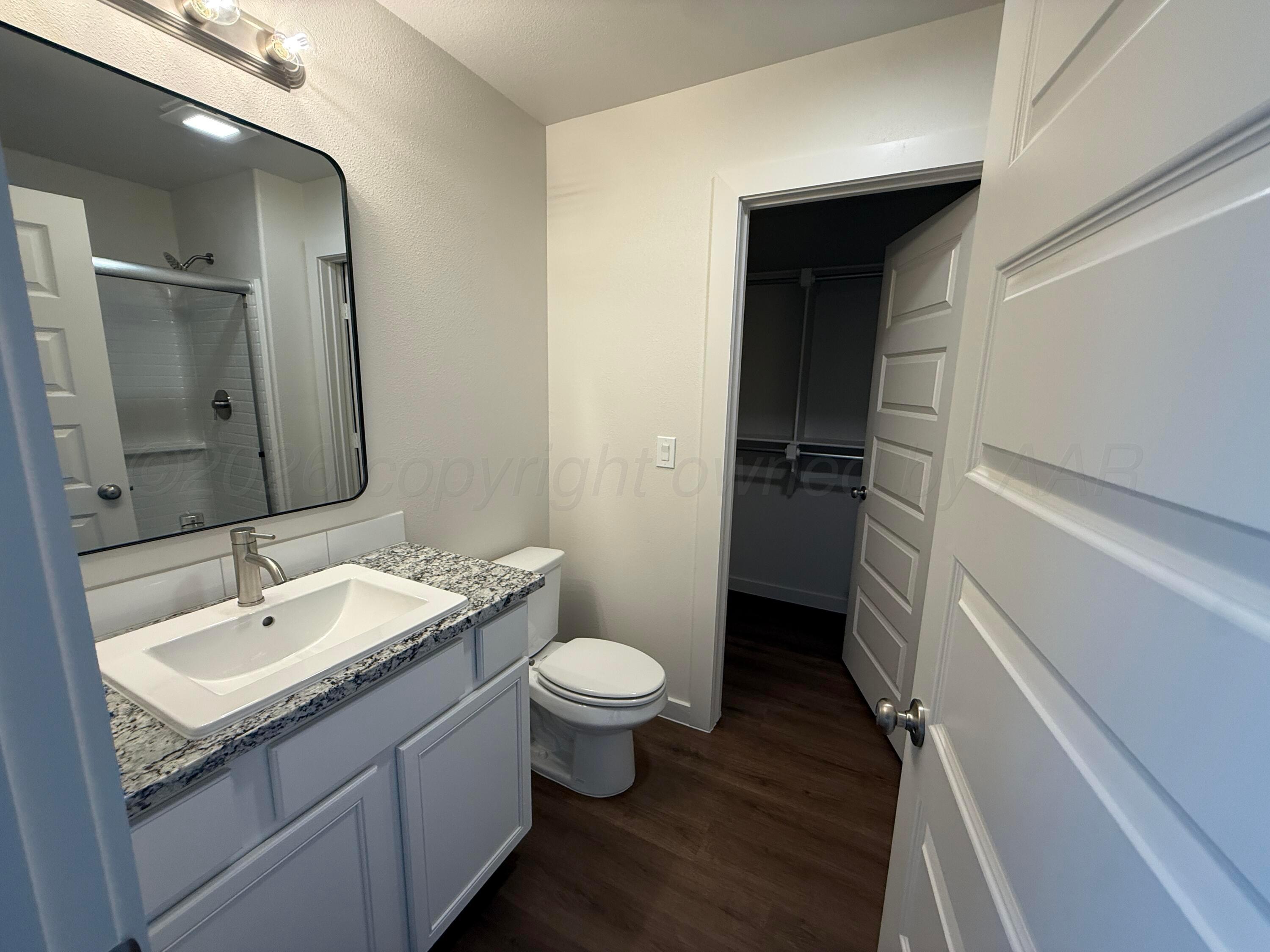 2911 Ranch House Road Amarillo, TX 79124 - Photo 13 of 18 a bathroom with a sink and a mirror