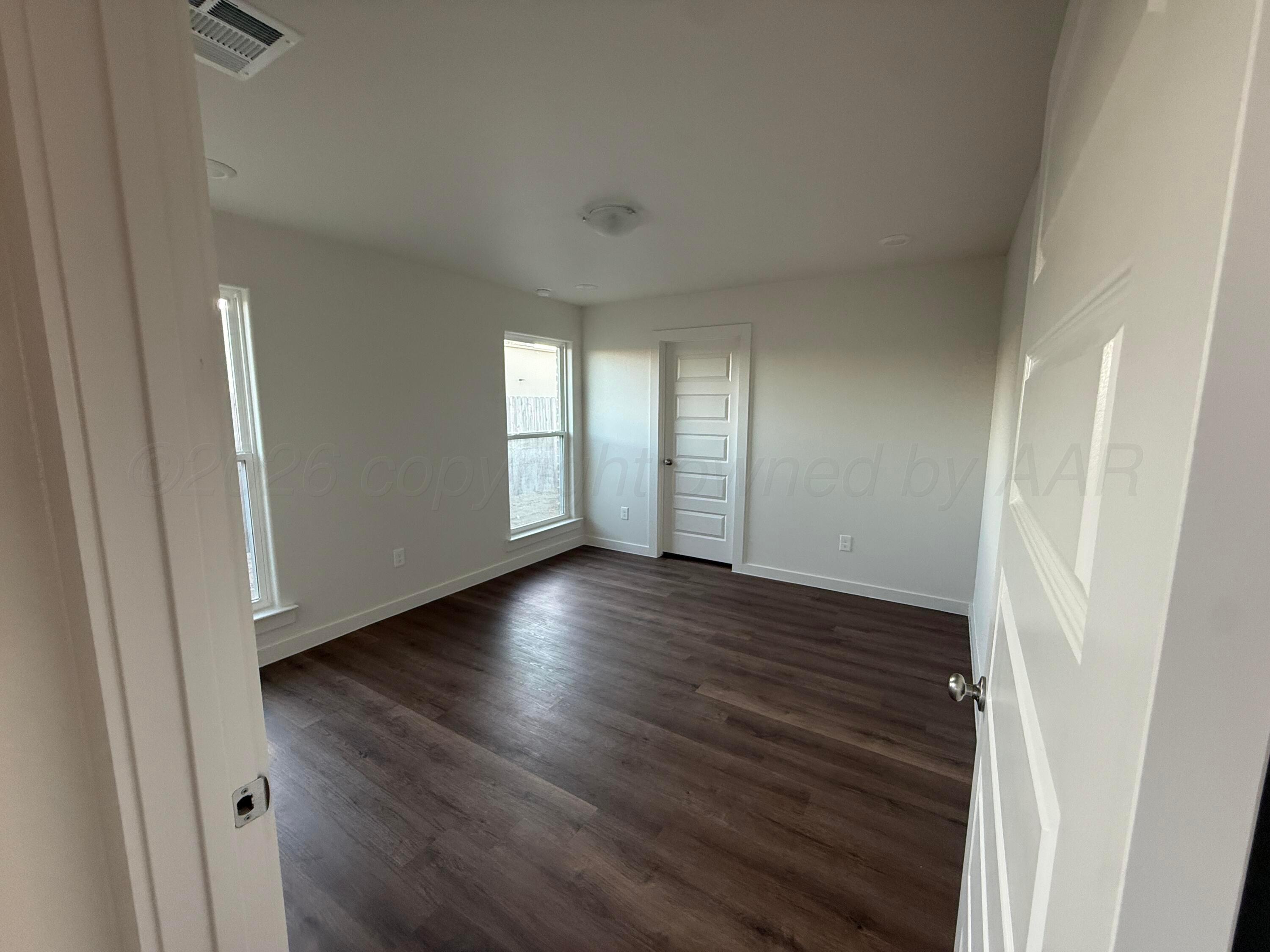 2911 Ranch House Road Amarillo, TX 79124 - Photo 15 of 18 a view of an empty room with wooden floor and a window