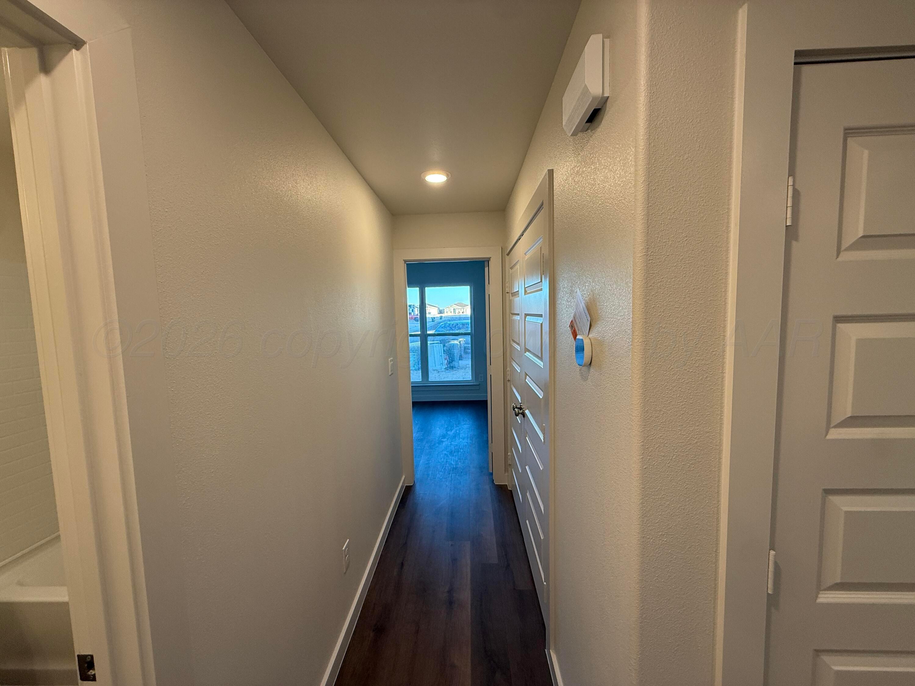 2911 Ranch House Road Amarillo, TX 79124 - Photo 17 of 18 a view of a hallway with wooden floor