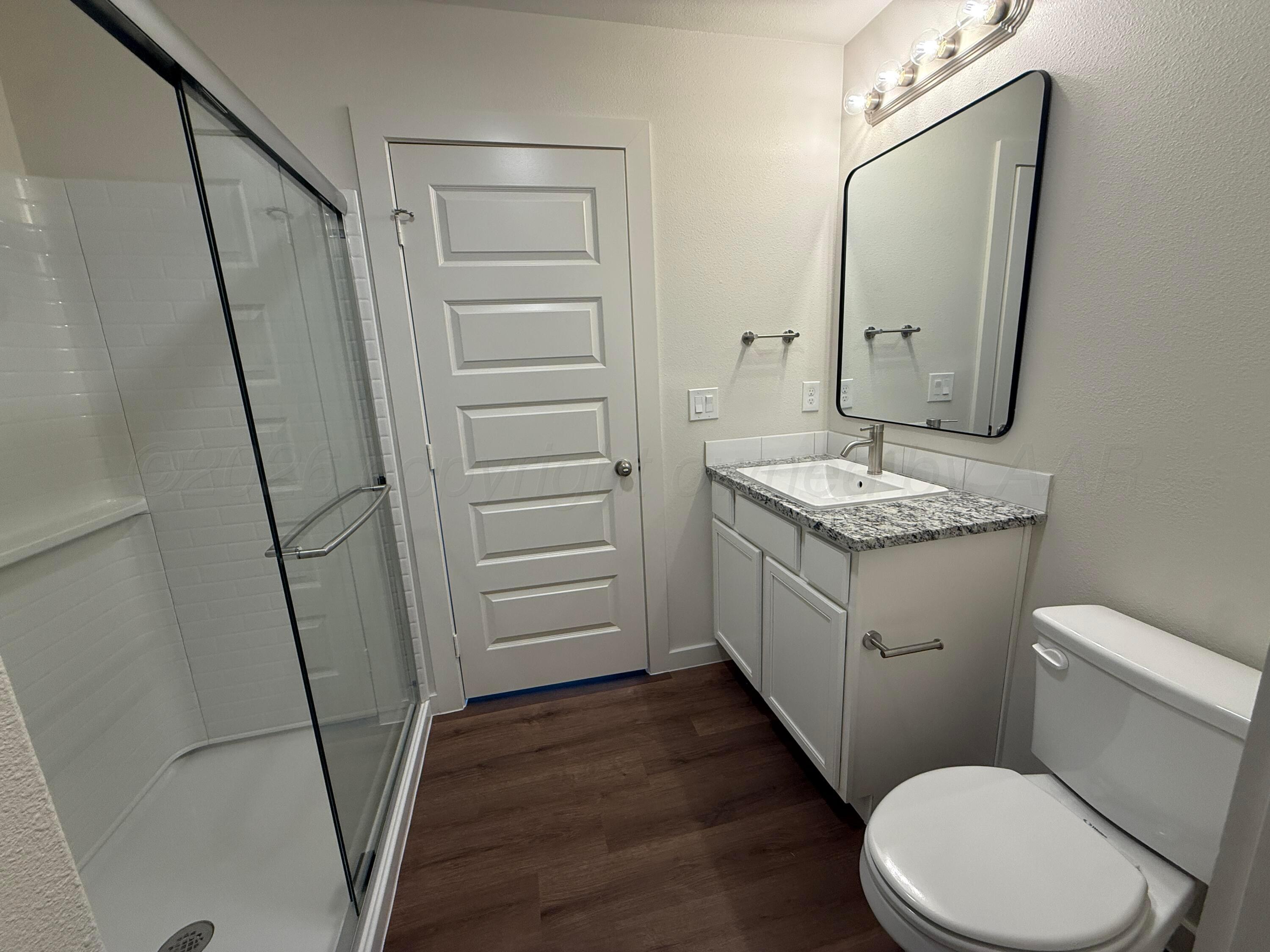 2911 Ranch House Road Amarillo, TX 79124 - Photo 10 of 18 a bathroom with a granite countertop sink toilet and shower