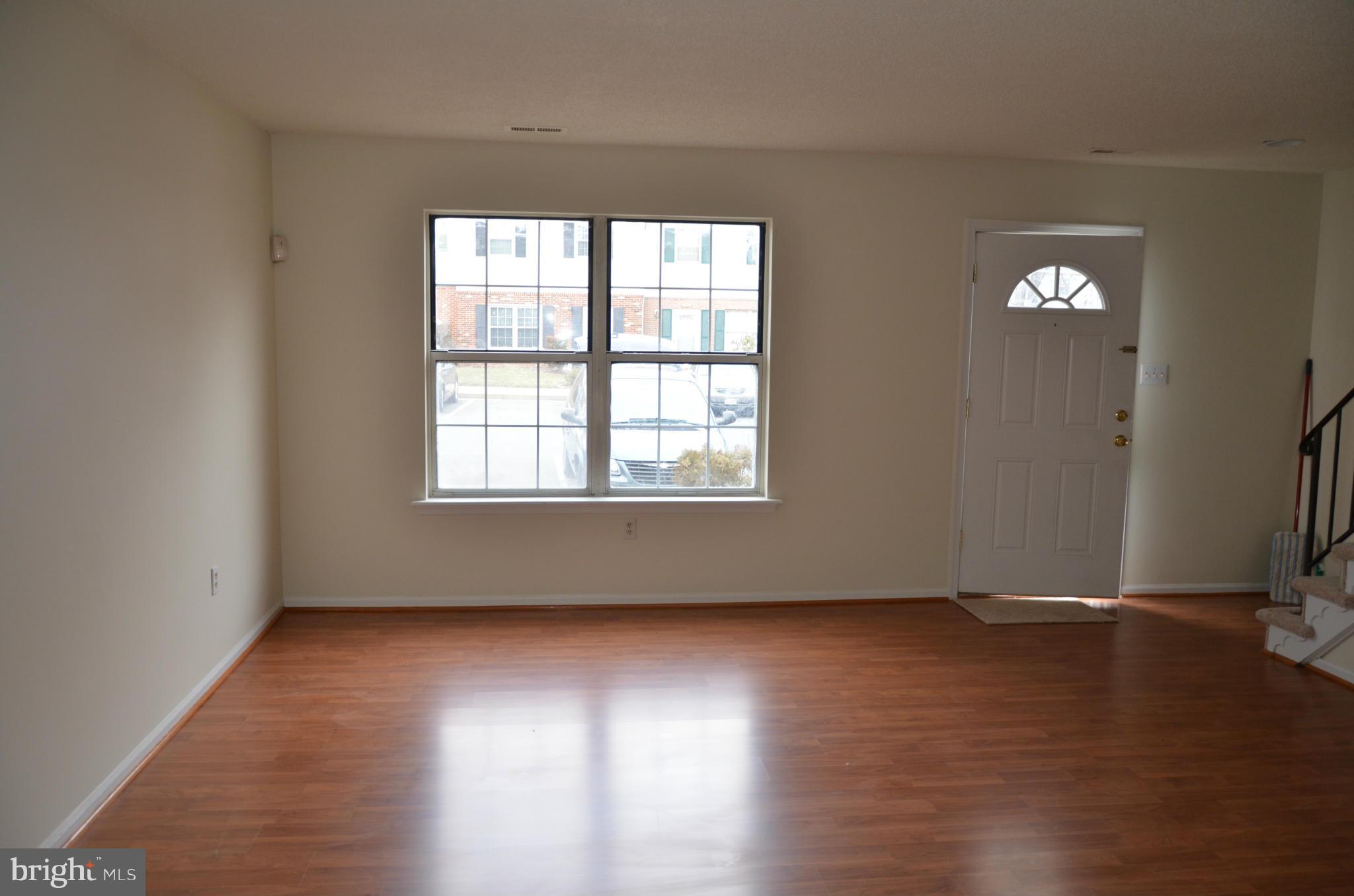 3626 Anchorage Cove Triangle, VA 22172 - Photo 2 of 11 an empty room with wooden floor and windows