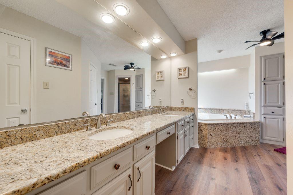 83 Crown Road Willow Park, TX 76087 - Photo 16 of 35 Dual vanity with granite countertops, undermount sinks, and brushed nickel fixtures