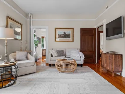 a bedroom with furniture and a flat screen tv