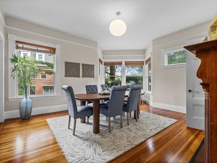 a view of a dining room with furniture window and wooden floor