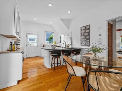 a view of a dining room with furniture and a potted plant