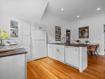 a kitchen with a refrigerator and a stove top oven