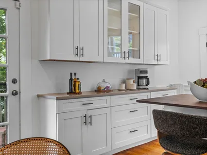 a kitchen with cabinets appliances and a sink