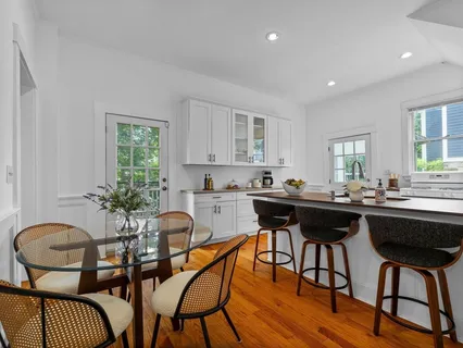 a kitchen with a table chairs stove and cabinets