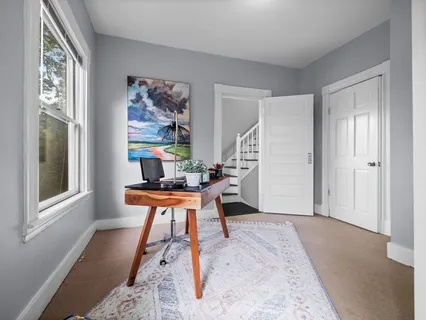 a work room with furniture and wooden floor