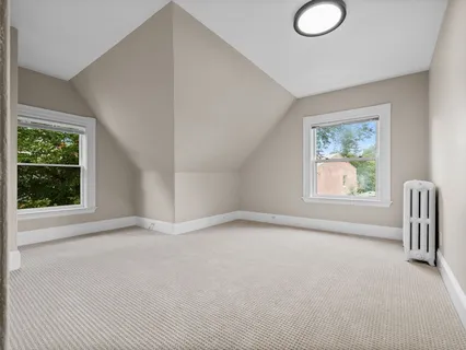 an empty room with a empty space and windows