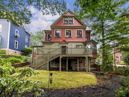 a view of a house with wooden deck