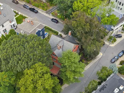 an aerial view of residential houses with outdoor space and swimming pool