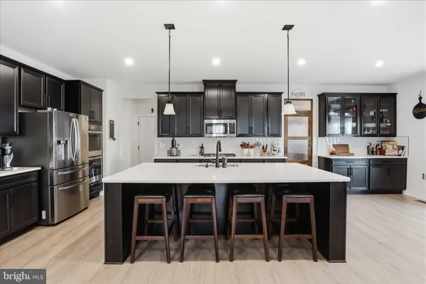 a large kitchen with stainless steel appliances lots of counter space and breakfast area