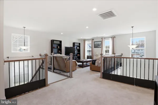 a spacious bedroom with a bed furniture and a ceiling fan