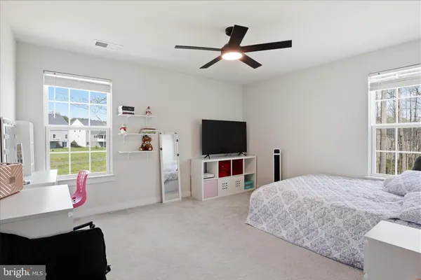 a bedroom with a bed and a desk