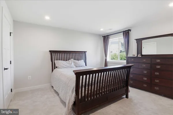 a view of a street with a big yard and a large tree