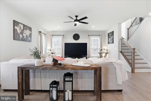a living room with furniture and kitchen view