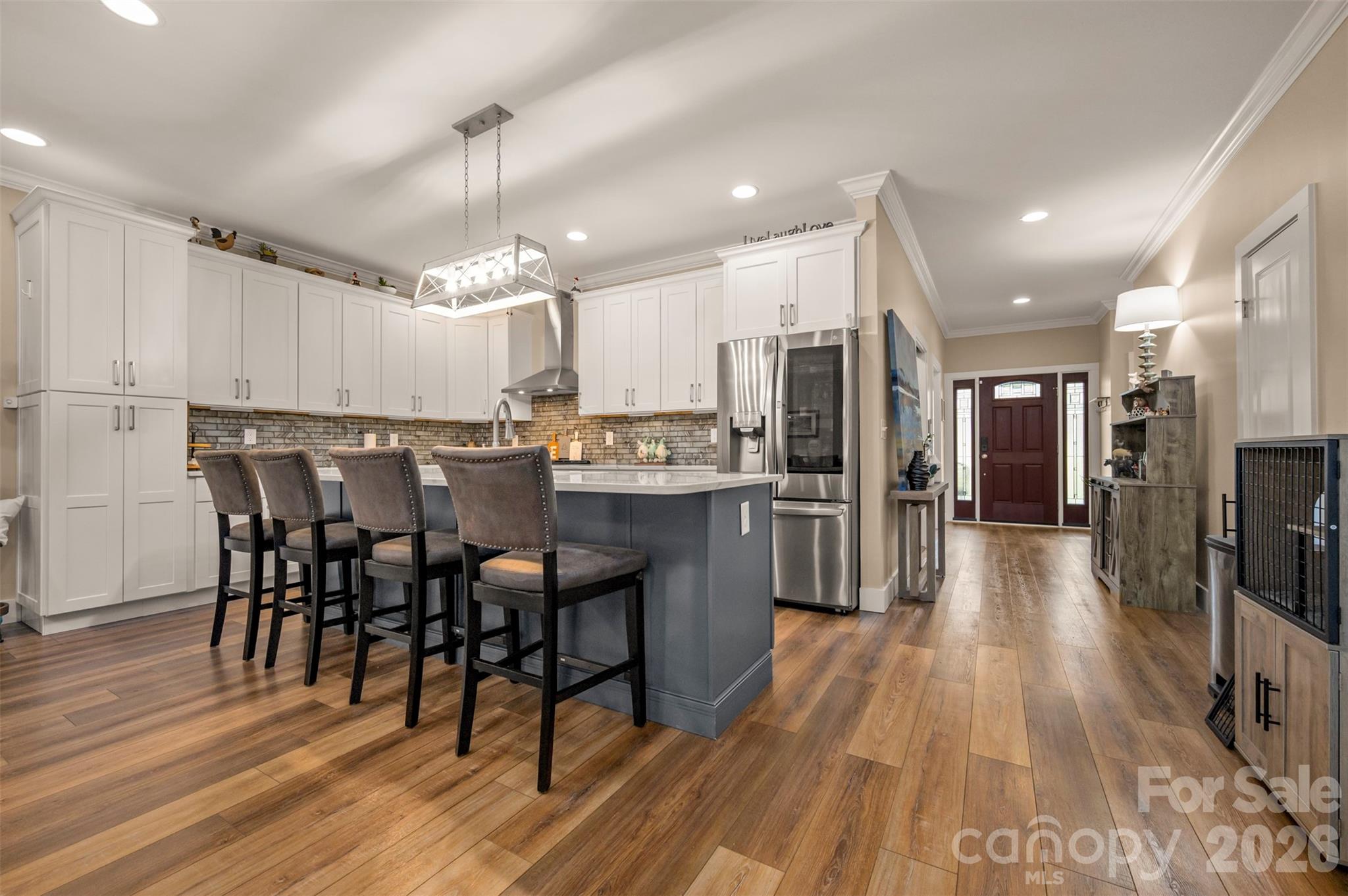 457 Edwards Street Extension Rutherfordton, NC 28139 - Photo 16 of 39 a kitchen with stainless steel appliances a dining table chairs and wooden floor