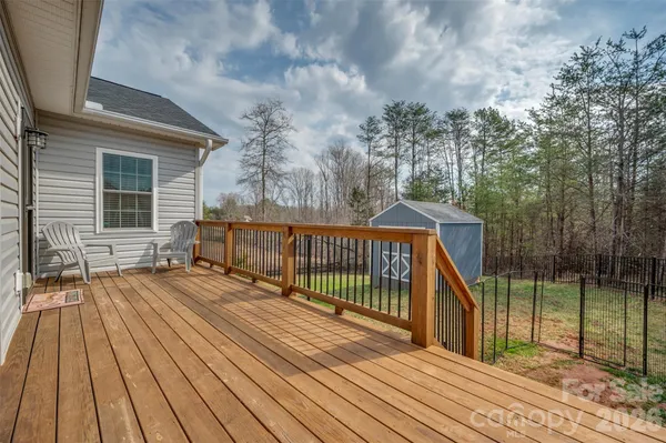 a view of backyard with deck and wooden floor