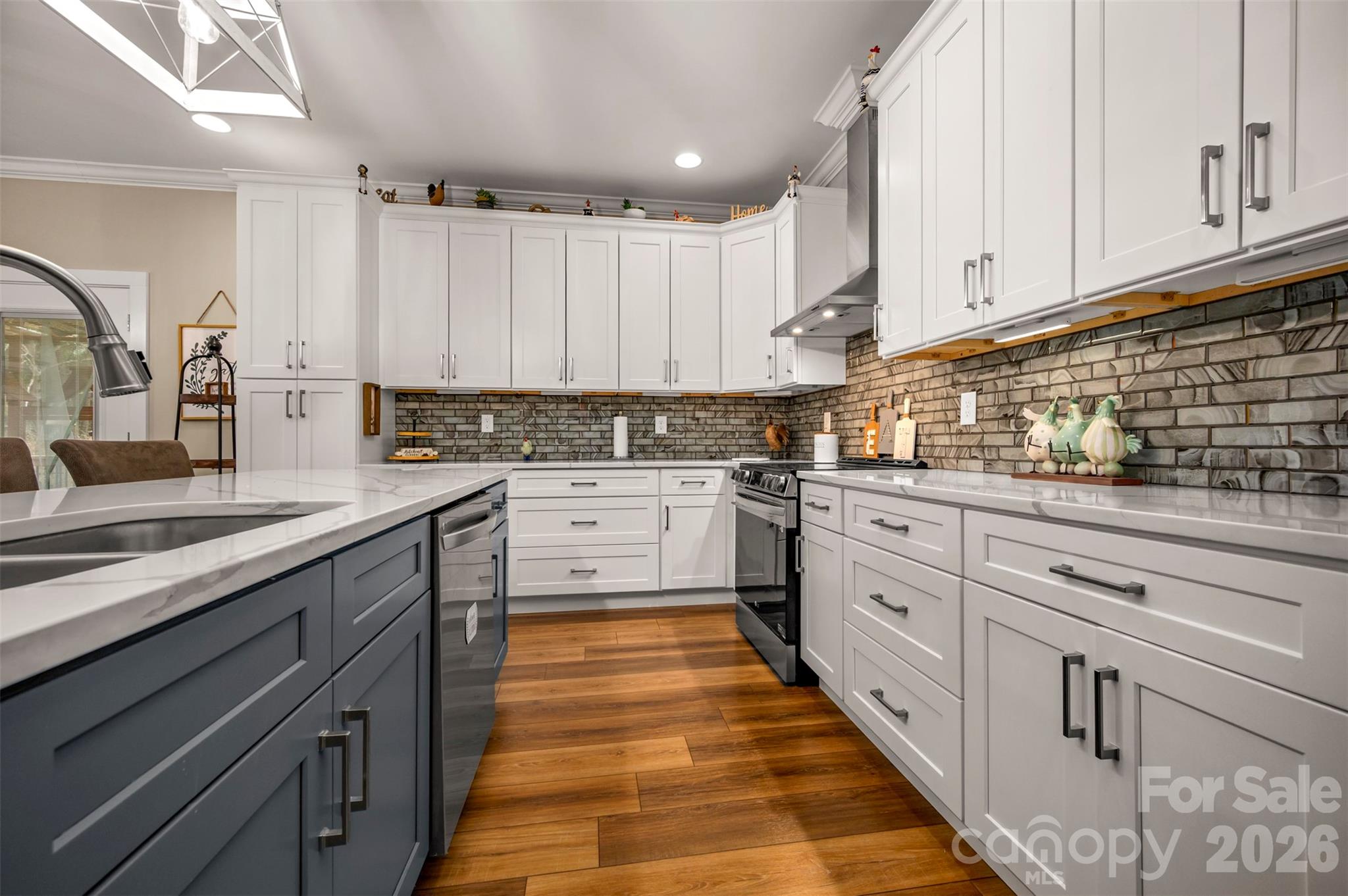 457 Edwards Street Extension Rutherfordton, NC 28139 - Photo 5 of 39 a kitchen with granite countertop a sink stove and cabinets