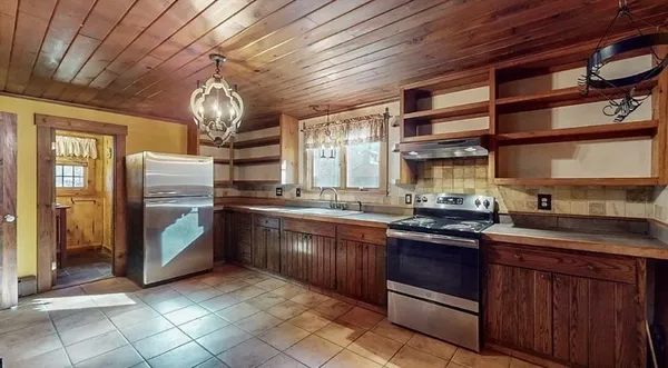 a kitchen with stainless steel appliances granite countertop a sink and cabinets