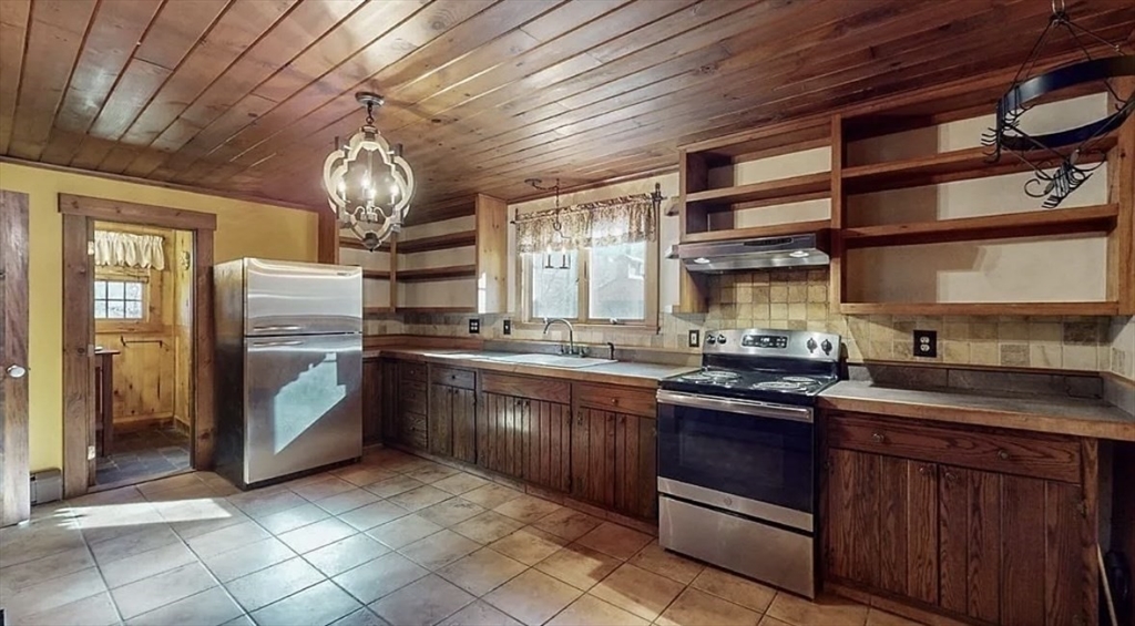 203 Brooks Road Templeton, MA 01468 - Photo 4 of 11 a kitchen with stainless steel appliances granite countertop a sink and cabinets