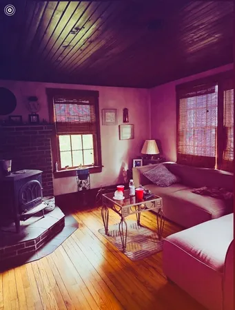 a living room with furniture a rug and a table