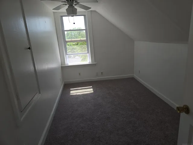 an empty room with windows and entrance