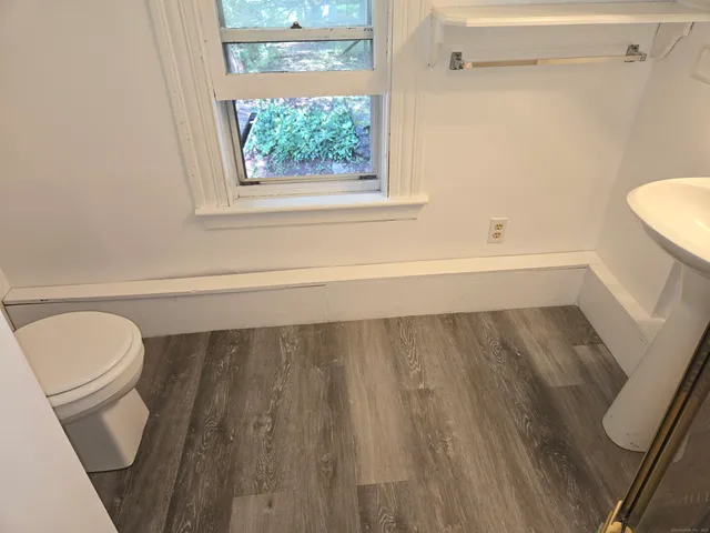 a bathroom with a toilet and a bathtub