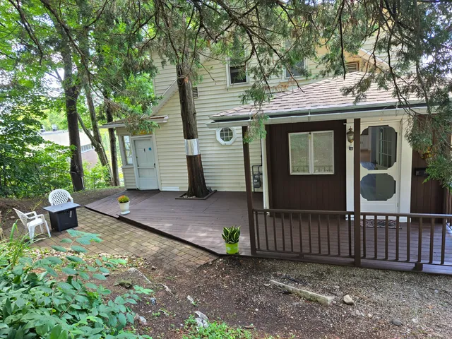 a view of a house with a yard and wooden fence