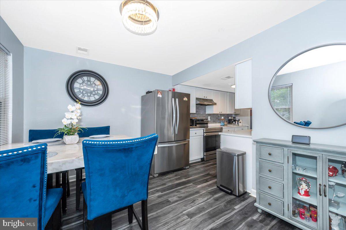 8826 Stauffer Road Walkersville, MD 21793 - Photo 11 of 38 a kitchen with a table chairs and a stove