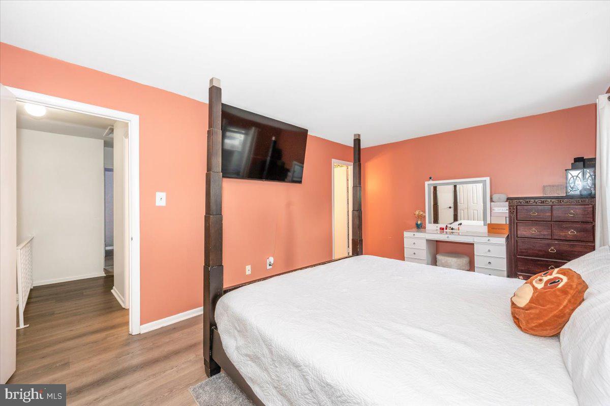 8826 Stauffer Road Walkersville, MD 21793 - Photo 24 of 38 a bedroom with a bed and dresser with wooden floor