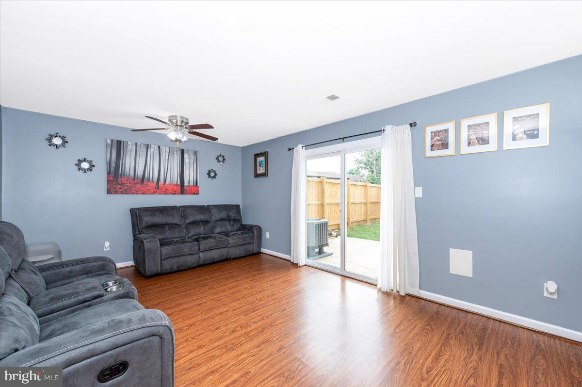 8826 Stauffer Road Walkersville, MD 21793 - Photo 4 of 38 a living room with furniture a flat screen tv and a window