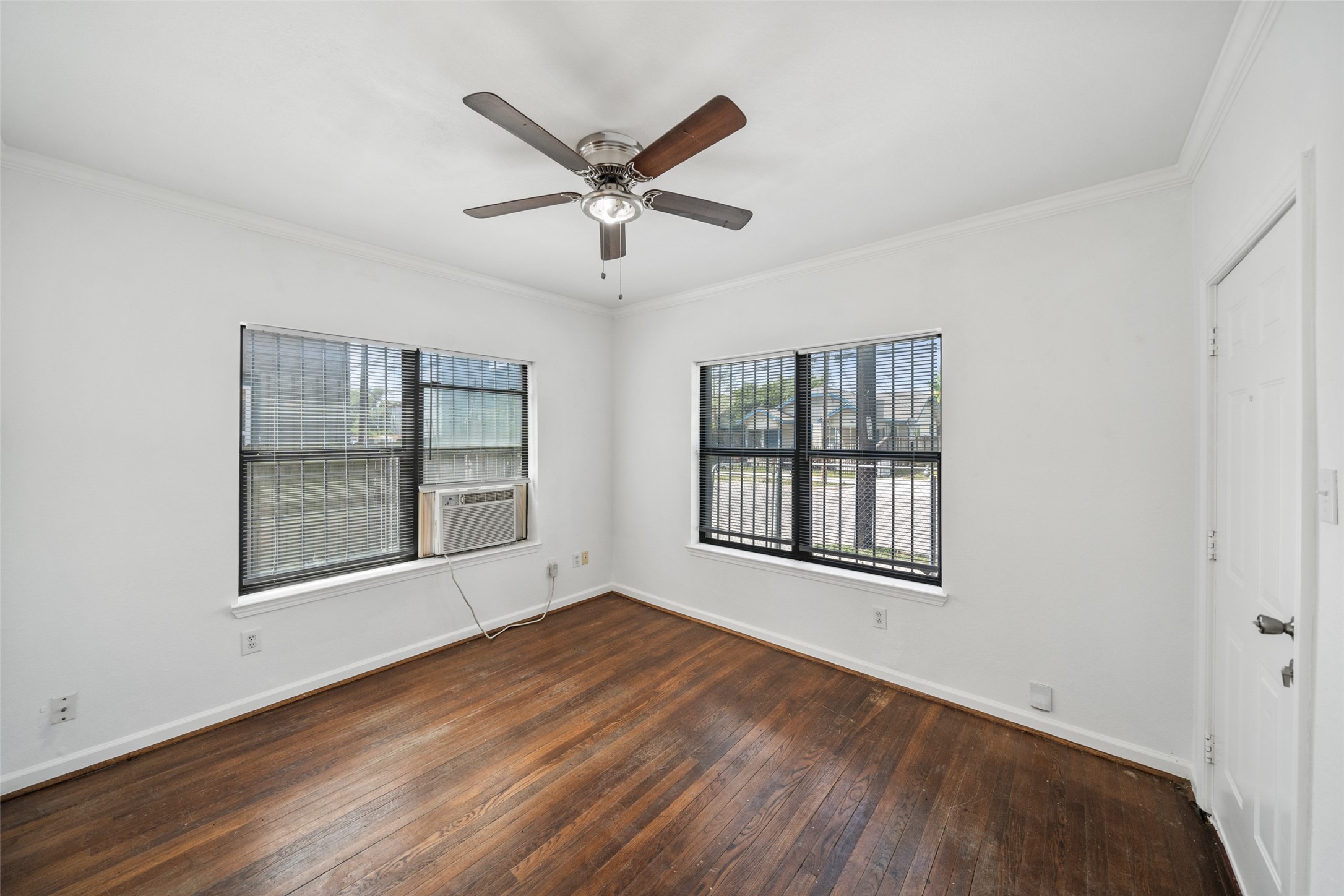 406 Quitman Street, Unit 2 Houston, TX 77009 - Photo 4 of 22 a view of an empty room with a window and wooden floor