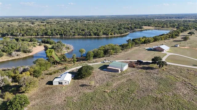 an aerial view of a house with a lake view