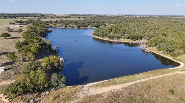 view of a lake with houses in the back