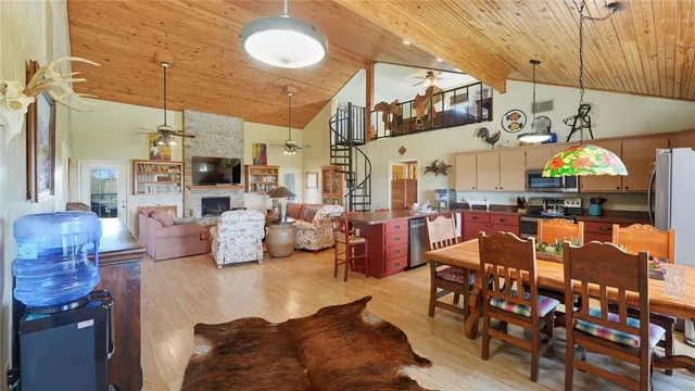 a living room with lots of furniture and chandelier
