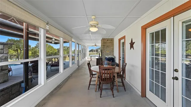 a view of a dining room with furniture large windows and wooden floor