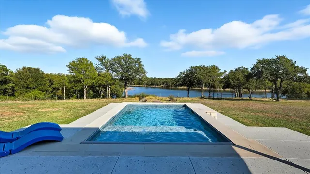 a view of a swimming pool with a yard