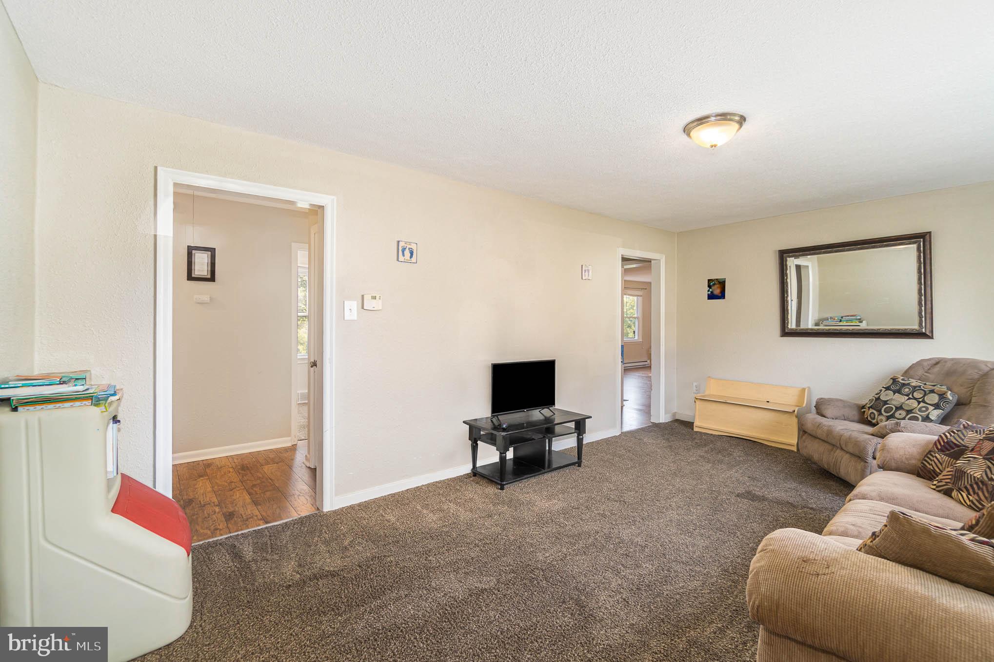 404 Beaumont Road York, PA 17403 - Photo 12 of 26 a living room with furniture and a flat screen tv